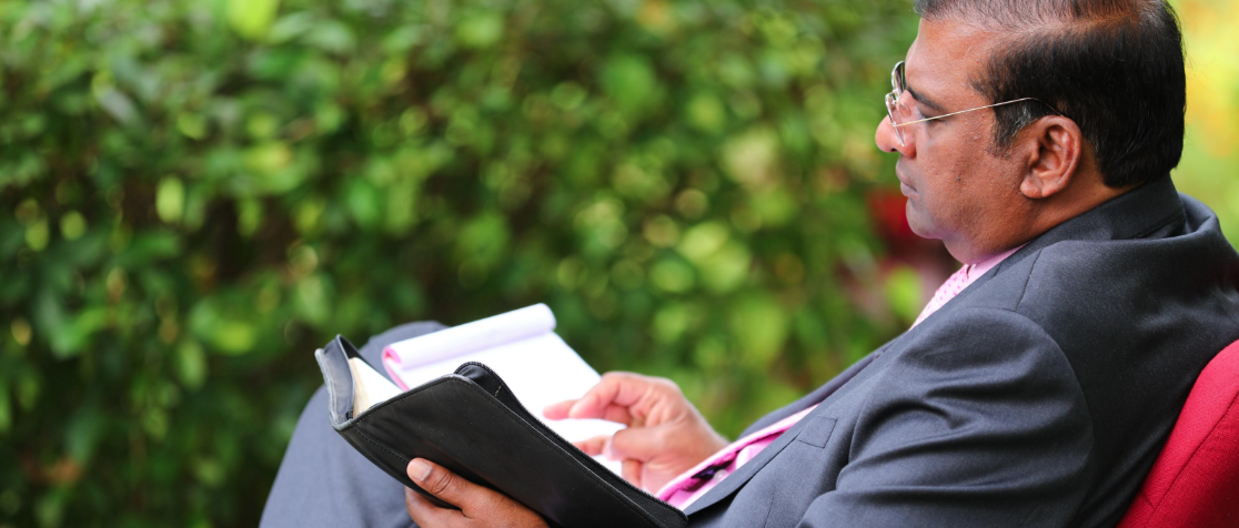 Dr. Paul Dhinakaran reading Bible